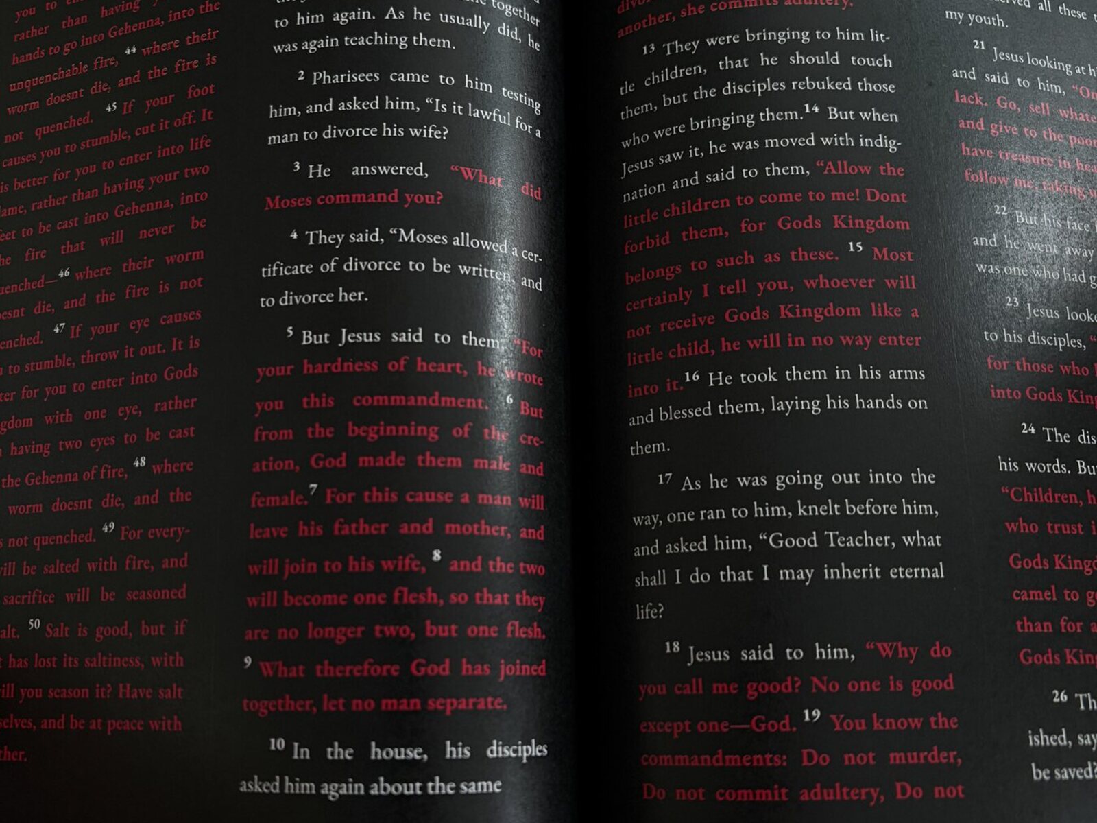 Real Premium Black Bible order opened to black pages with white and red scripture